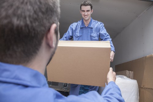 Professional piano movers handling an upright piano in Crystal Palace