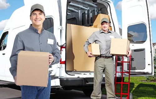 Van loading scene showing careful handling and insurance-backed moving service